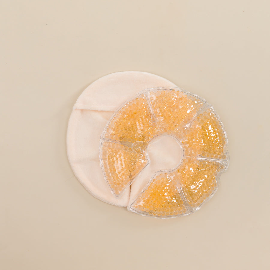Compresse chaude/froide réutilisable Jolly Mama, remplie de petites billes orange, conçue pour soulager la poitrine pendant l’allaitement.